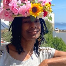 Image of a person wearing a hat made of colourful flowers